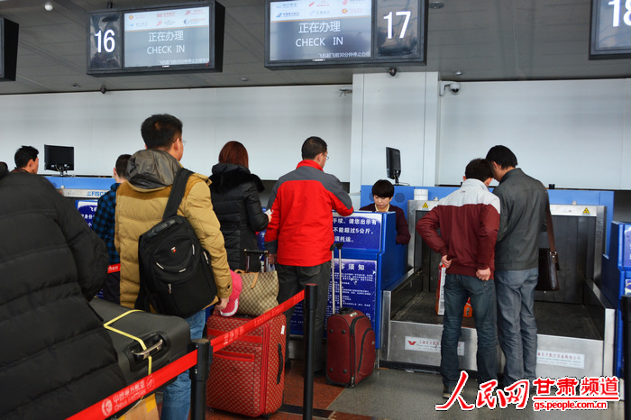 兰州中川机场,乘客正在换取登机牌和办理托运手续.(高翔 摄)