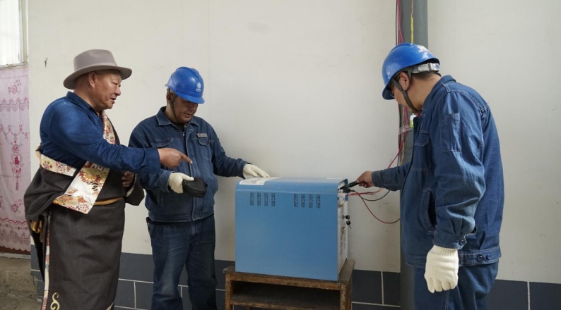 供電員工在牧民家中檢查用電情況。李旋攝