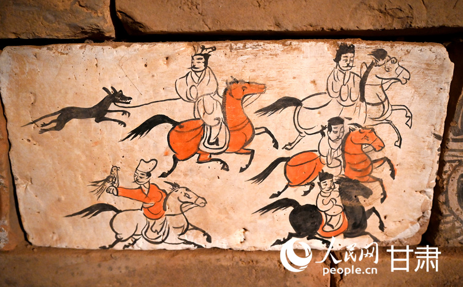 駱駝城苦水1號墓復原墓葬—射獵圖壁畫磚（復制品）。